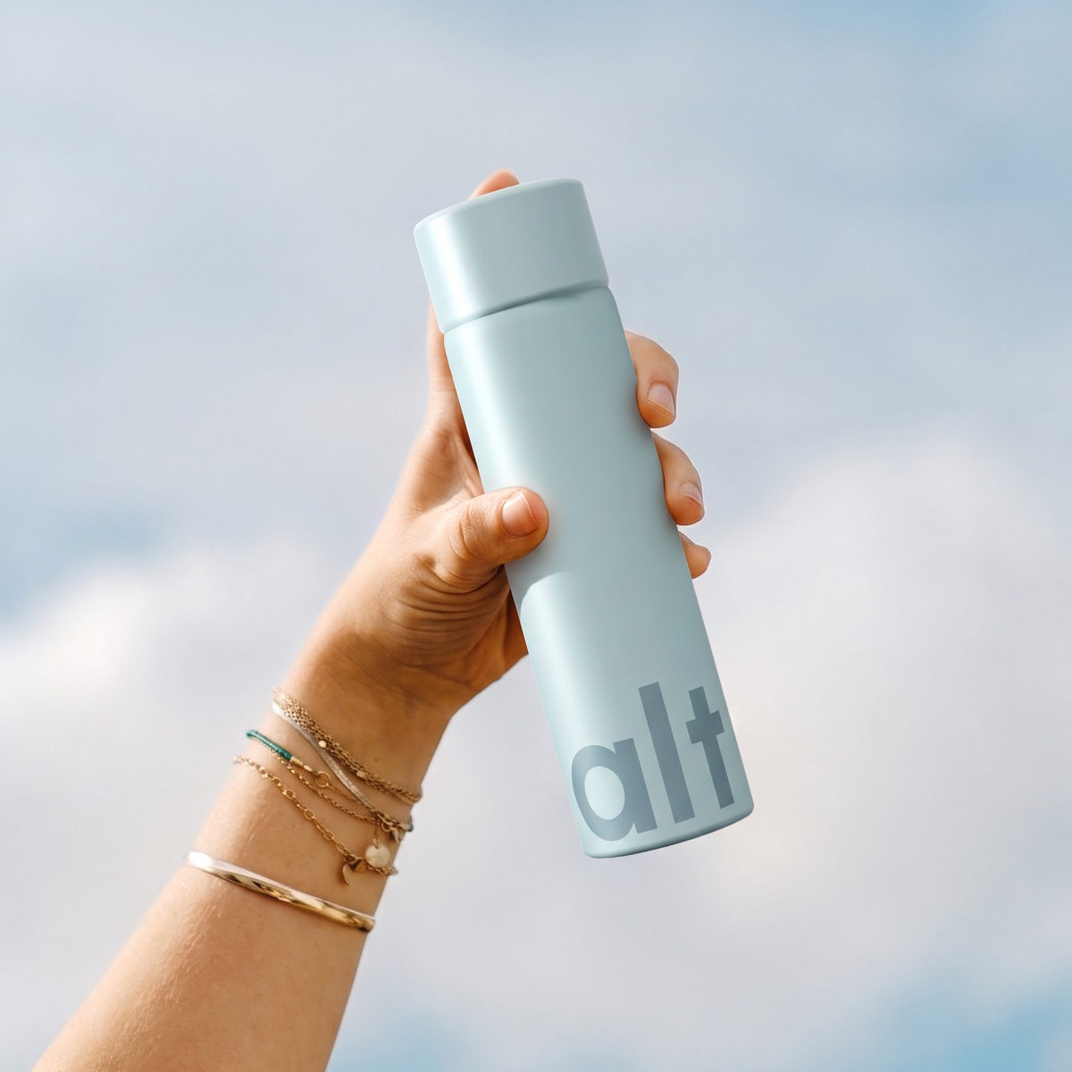 An Alt bottle held up against a blue sky